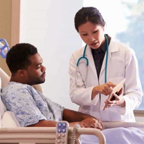 Nurse explaining information to patient in hospital