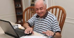 Man Researching Medicare Options Using Computer