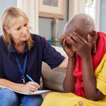 Female presenting social worker consoling and caring for someone who is upset.